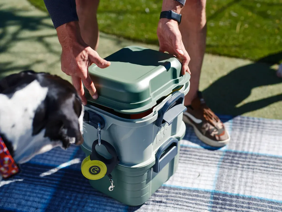 Closing Basecamp's weather-resistant exterior shell with leash clipped to an accessory mount.
