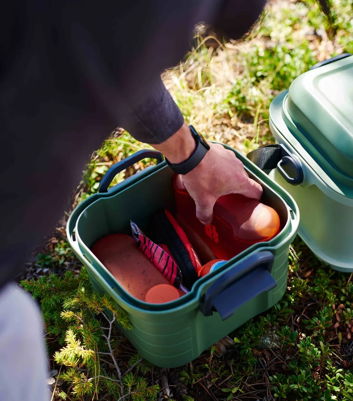 Hand packing gear, treats, and first aid into Basecamp's lower tier.