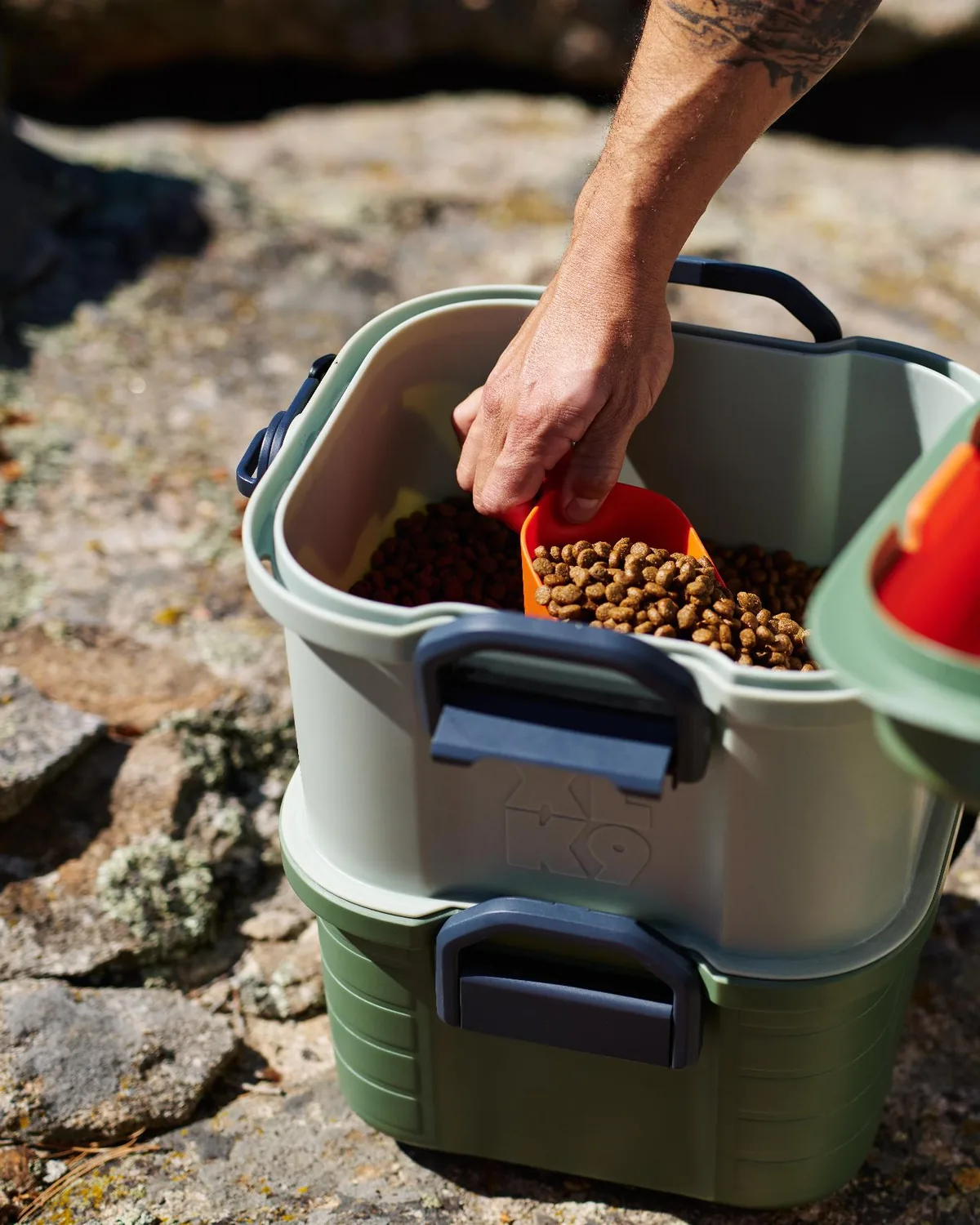 Scooping kibble from Basecamp's divided middle-tier food storage.